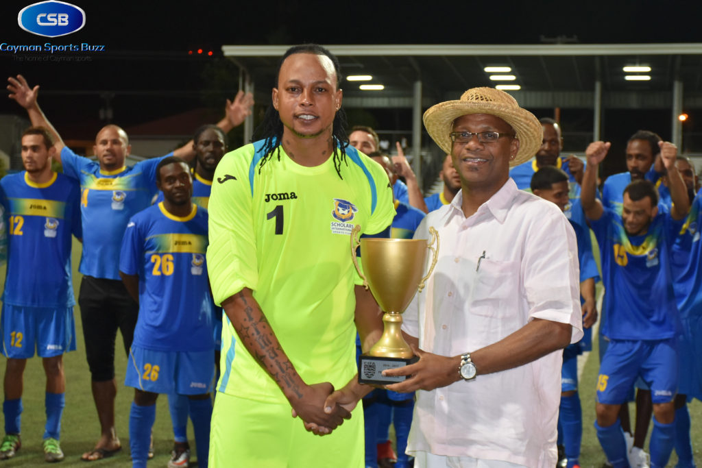 Scholars capt. Jermaine Brown gets cup from CIFA President Lee Ramoon
